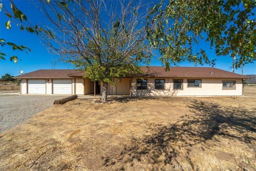 Custom stick built home on 5.68 acres in Anza. This home has 2 bedrooms and 2 bathrooms, spacious living room with dining area opens into a large kitchen with plenty of cabinetry and countertop space. The home is clean and move in ready and has central AC and heat. The lot is flat as a pancake and fully fenced. There is an oversize 2 car garage with workshop space and breezeway between home and garage. This property has a great location very close to paved road. This property is served by a private well and a few mature trees around the home along with great mountain views. Presenting a unique opportunity for the right buyer adjacent commercially zoned lots owned by same owner could be sold separately for anyone interested in a residence adjacent to their business. The zoning is R-R allowing for many opportunities including horse, cattle, chickens. This is a great property for anyone wanting flat land to homestead, grow garden and raise animals. Anza is located at 4000 foot elevation mid-way between Temecula and Palm Desert. Great mild 4 season weather. Come take a look today. (951) 203-1603